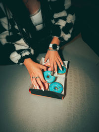 A woman eats off a piece of a donut