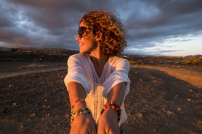 Full length of young woman standing on beach