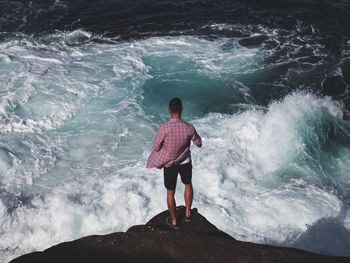 High angle view of man standing on beach