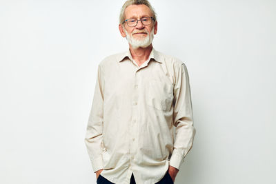 Portrait of man standing against white background