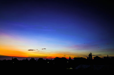 Silhouette of trees against sky at sunset