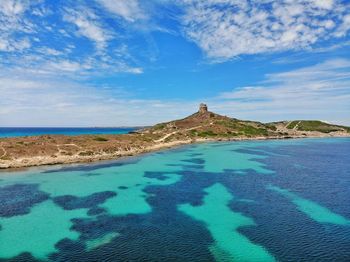 Scenic view of beach against blue sky