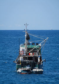 Sailboat sailing on sea against sky