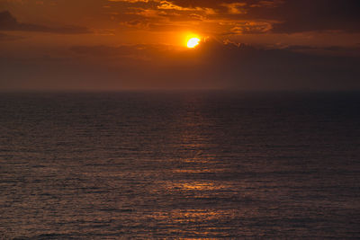 Scenic view of sea against romantic sky at sunset