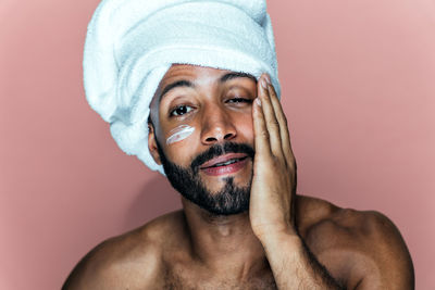 Low angle view of shirtless young man against white background