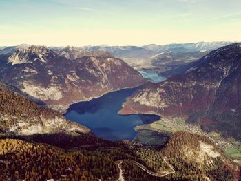 Scenic view of lake and mountains against sky