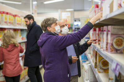 Couple wearing protective mask in supermarket