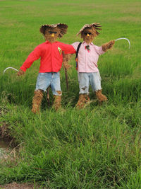 View of scarecrows on agriculture field