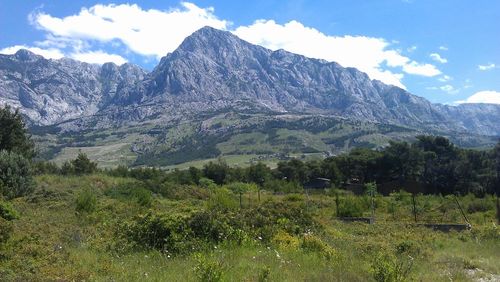 Scenic view of mountains against cloudy sky