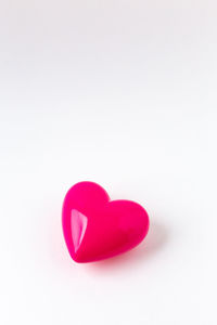 Close-up of heart shape on pink over white background