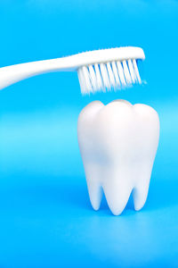 Close-up of toothbrush over dentures on table