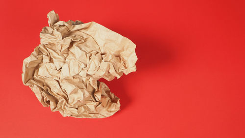 High angle view of paper against red background