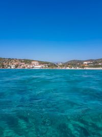 Scenic view of sea against clear blue sky