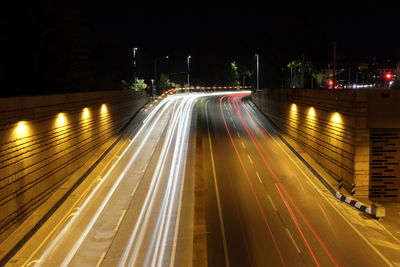 High angle view of light trails on road at night