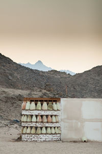 Stack of stone wall against mountain range against clear sky