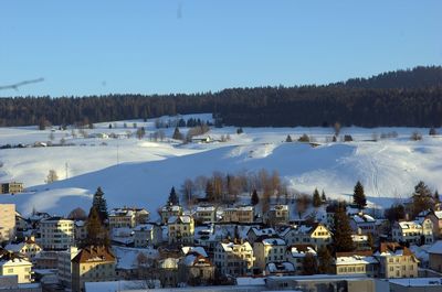 High angle view of houses and trees during winter