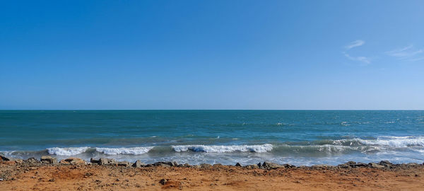 Scenic view of sea against clear blue sky