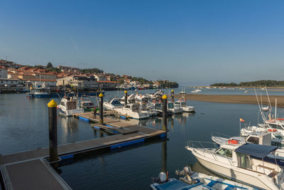 Boats moored at harbor