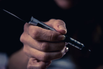 Close-up of man holding cigarette