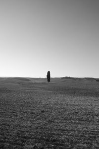 Man on field against clear sky