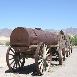 Bicycle on field against clear blue sky