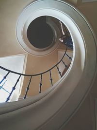 Low angle view of woman on spiral staircase at home