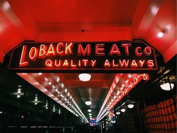 Low angle view of illuminated sign at night