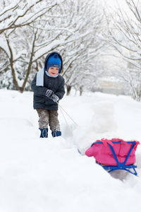 Boy in snow on land during winter