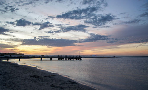 Scenic view of beach against sky during sunset