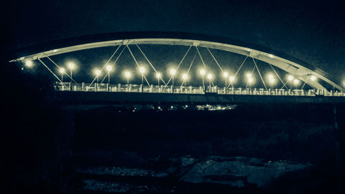 Bridge against sky at night