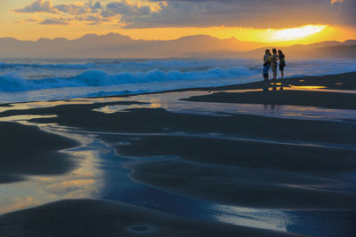 Scenic view of beach against sky during sunset