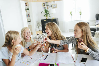 Girls having snack while they learning together