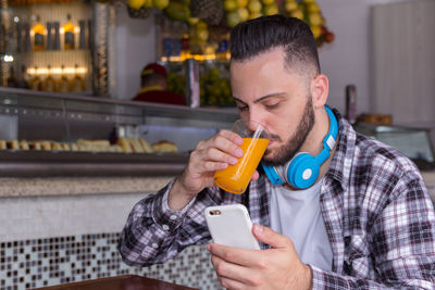 Midsection of man using mobile phone