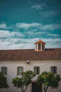 Houses in city against sky