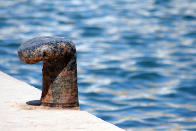 Close-up of cleat against sea