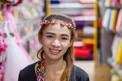 Close-up portrait of smiling young woman wearing tiara