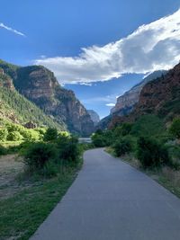 Road amidst mountains against sky