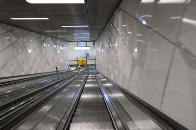 Rear view of man on escalator