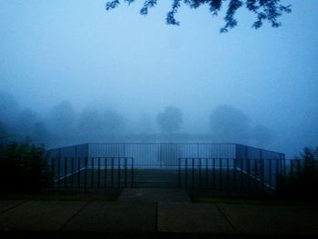 Scenic view of trees against sky during foggy weather