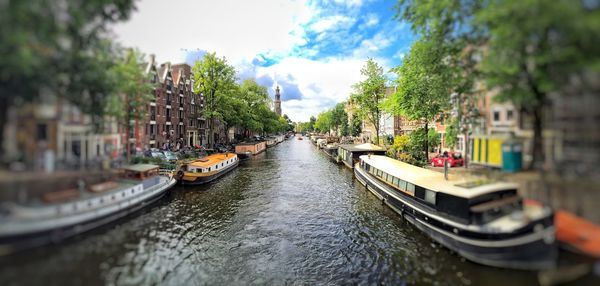 Boats in river with city in background