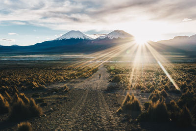 Scenic view of snowcapped mountains against sky during sunset