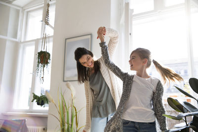 Happy mother with daughter at home