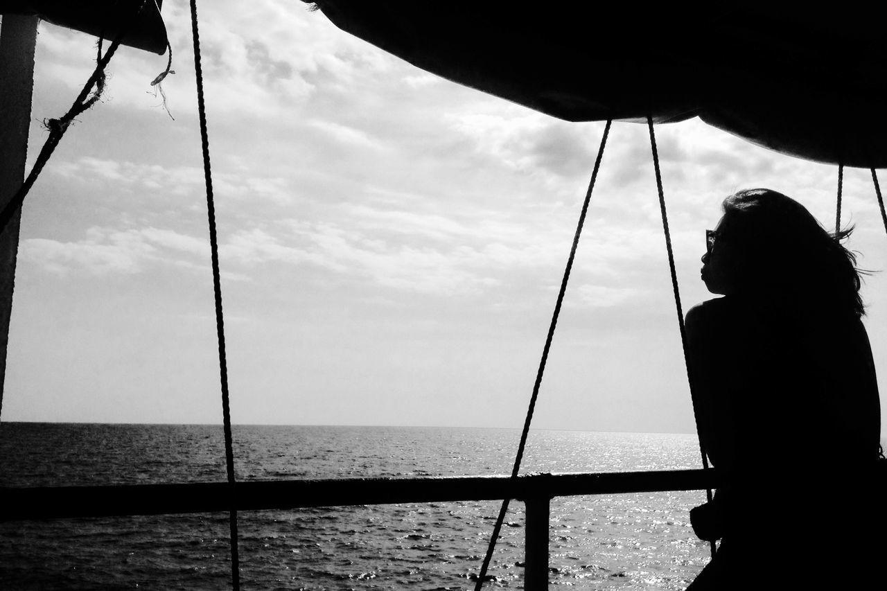 sea, water, sky, horizon over water, silhouette, nautical vessel, lifestyles, leisure activity, men, cloud - sky, nature, standing, rear view, scenics, person, cloud, boat, day