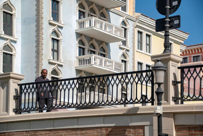 Man walking on staircase of building in city