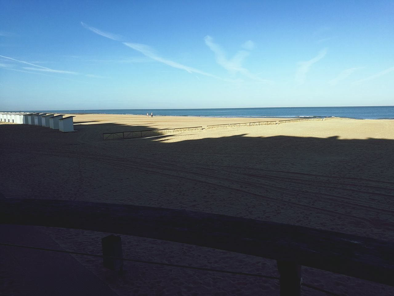 sea, water, beach, horizon over water, tranquil scene, scenics, sky, tranquility, sunlight, blue, sand, beauty in nature, shore, coastline, vacations, outdoors, nature, non-urban scene, vapor trail, day, tourism, summer, horizon, cloud - sky