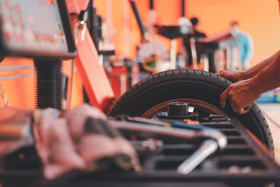 Cropped hand of man repairing car