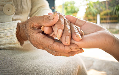 Close-up of couple holding hands