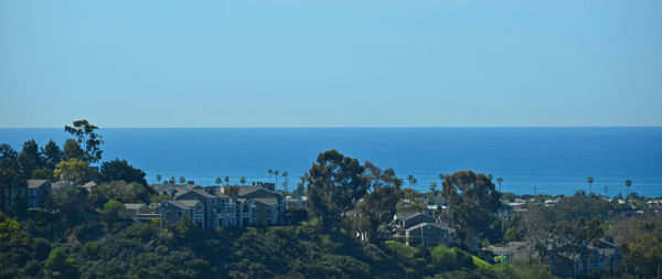 Panoramic view of sea and buildings against clear sky
