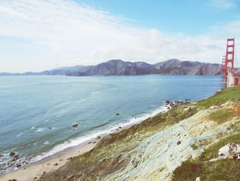 Scenic view of mountains against cloudy sky