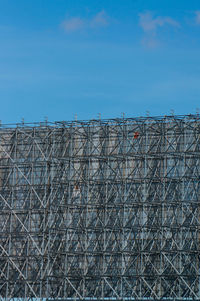 Low angle view of billboard against sky